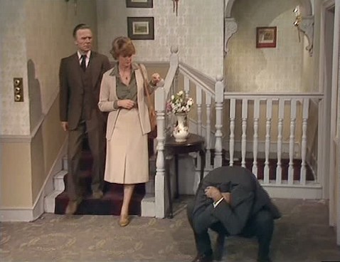 Basil Fawlty suffering one of his many failings and embarrassments