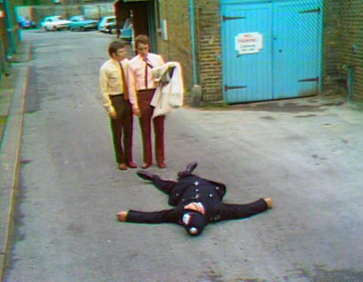 A policeman lying prostrate on the floor