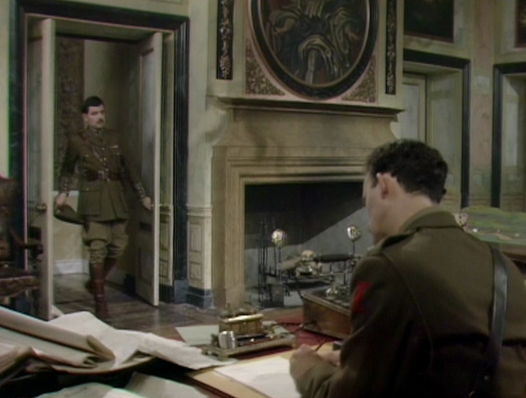 Blackadder and Darling in Melchett's office. Fireplace and circular portrait visible.