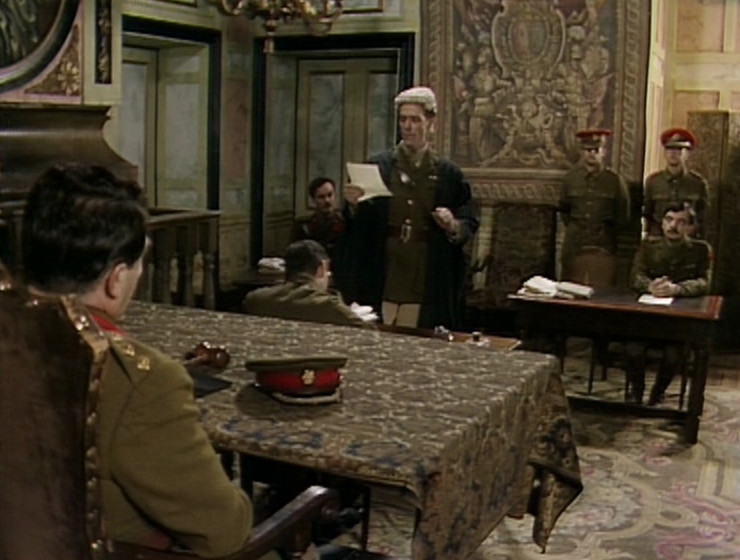 The courtroom, with the tapestry on the wall behind George