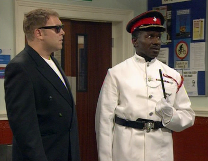 Gladstone looking a twat in his police dress uniform