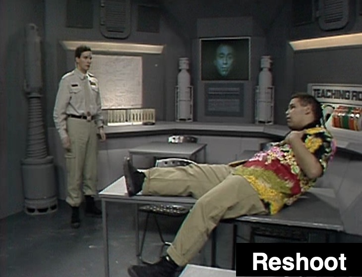 Rimmer and Lister puzzled in the Teaching Room learning about Cat, with Holly in vision