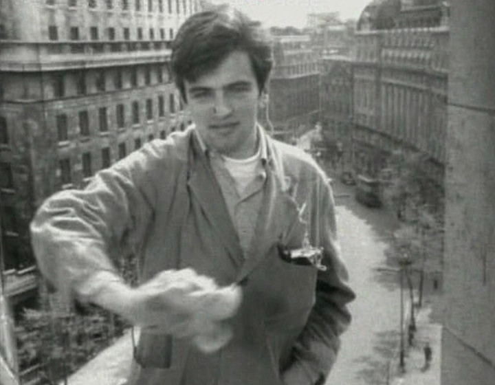 Man washing windows with portable radio in pocket