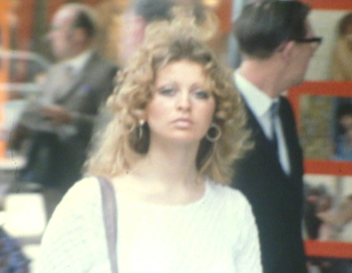 Woman with curly hair in street