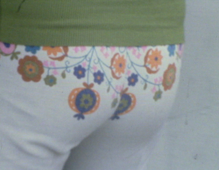 Close-up of a woman's bottom, wearing tight trousers