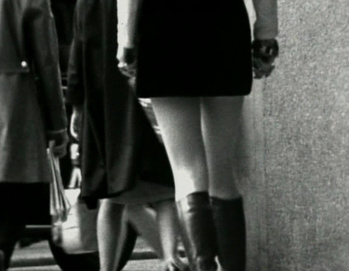 Lower half of woman wearing a skirt, from the back