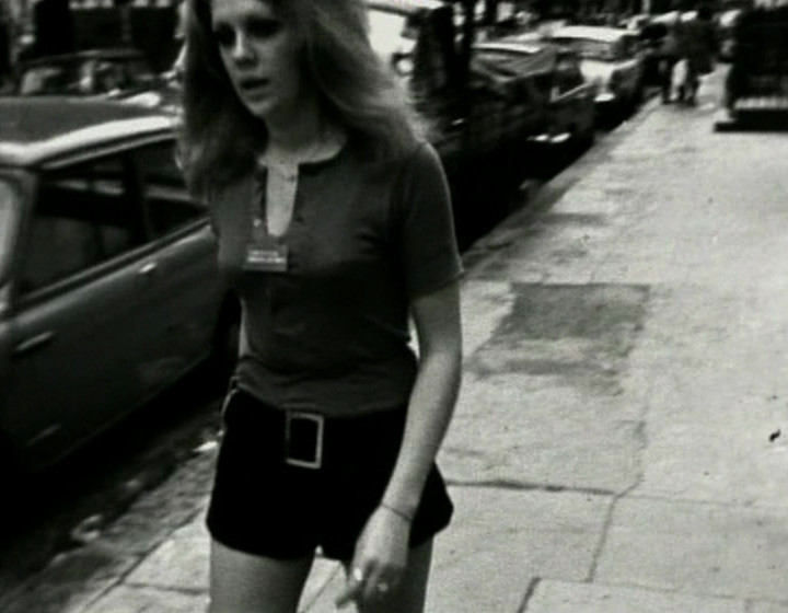 A different woman walking down the street, with long hair