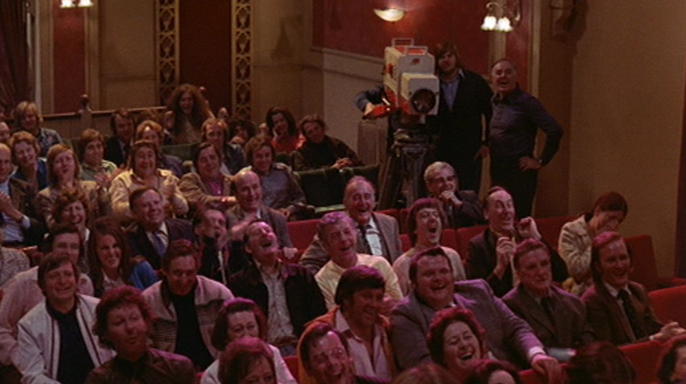 Carry on Girls: The audience of the beauty contest, with a red and cream camera on the right