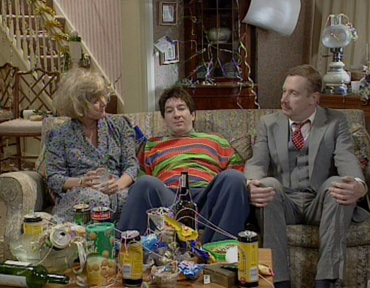 Maria McErlane, Simon Day, and Mark Williams as the alcoholic family, sitting on the sofa surrounded by the remnants of a party