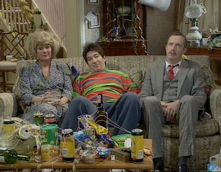 Mark Williams, Maria McErlane, and Simon Day sitting on the sofa as the Alcoholic Family