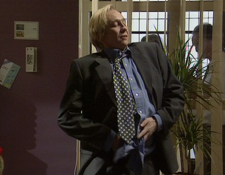 Paul Whitehouse in an office, adjusting his trousers theatrically